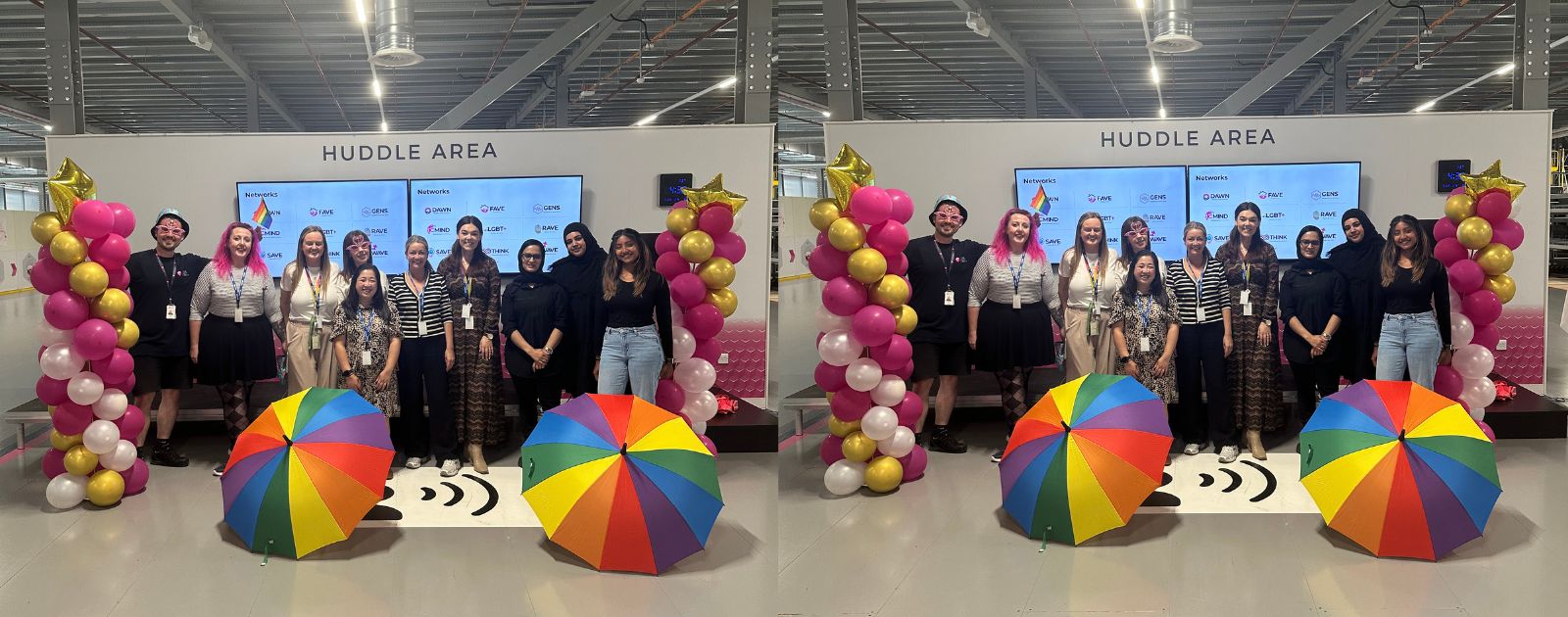 A group of colleagues stood close together surrounded by colourful balloons and Pride umbrellas